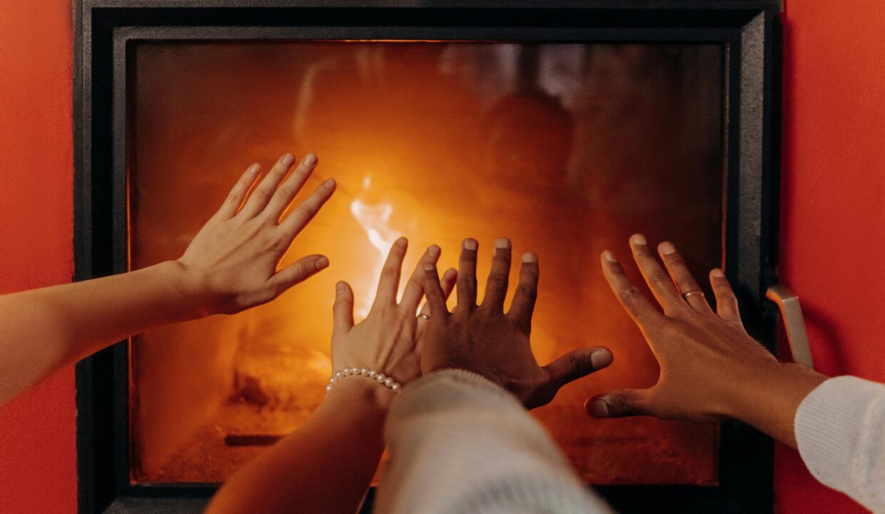 hands in front of fireplace at home